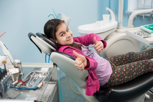 girl-visit-dentists-sits-chair-they-look-mirror-her-teeth_1429-7580