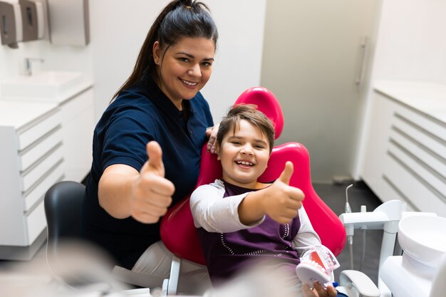 girl-visit-dentists-sits-chair-they-look-mirror-her-teeth_1429-7580